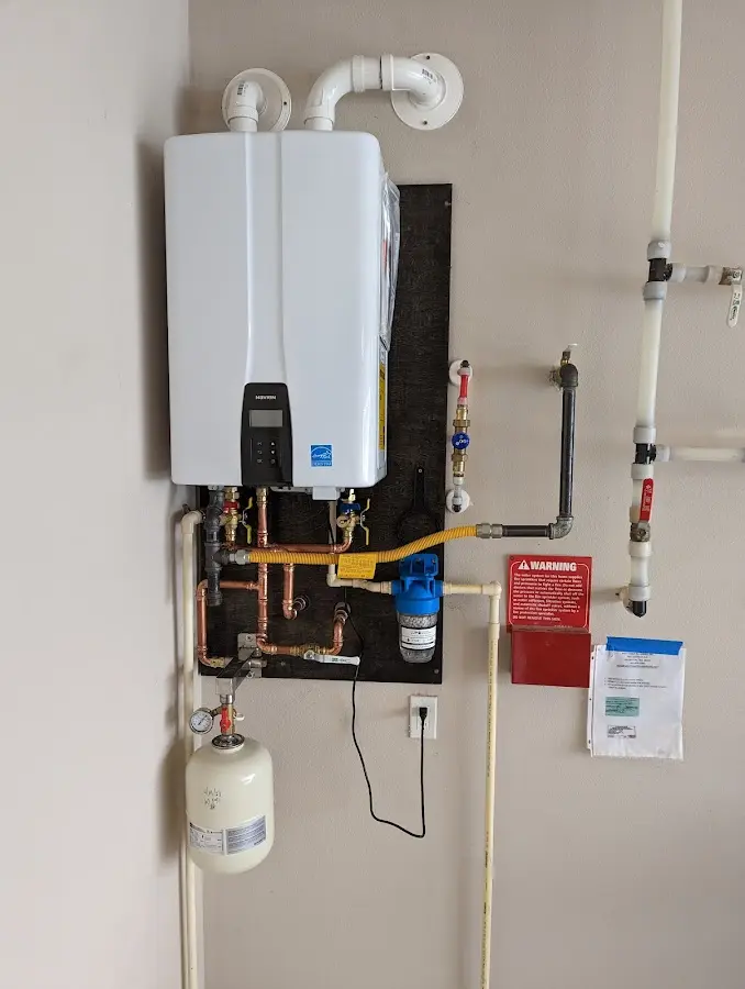 Professional plumber installing copper piping in a Marlborough home